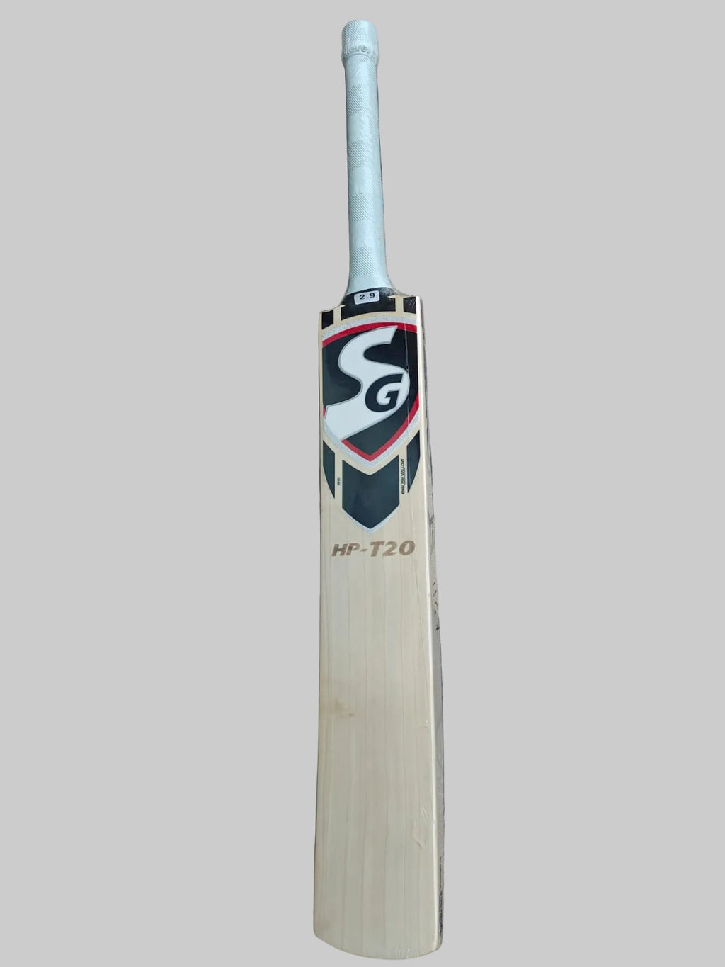 Cricket bat with SG logo on a hexagonal tiled floor