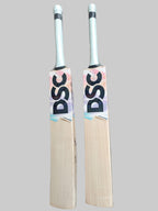 Two cricket bats with DSC branding on a hexagonal patterned floor.