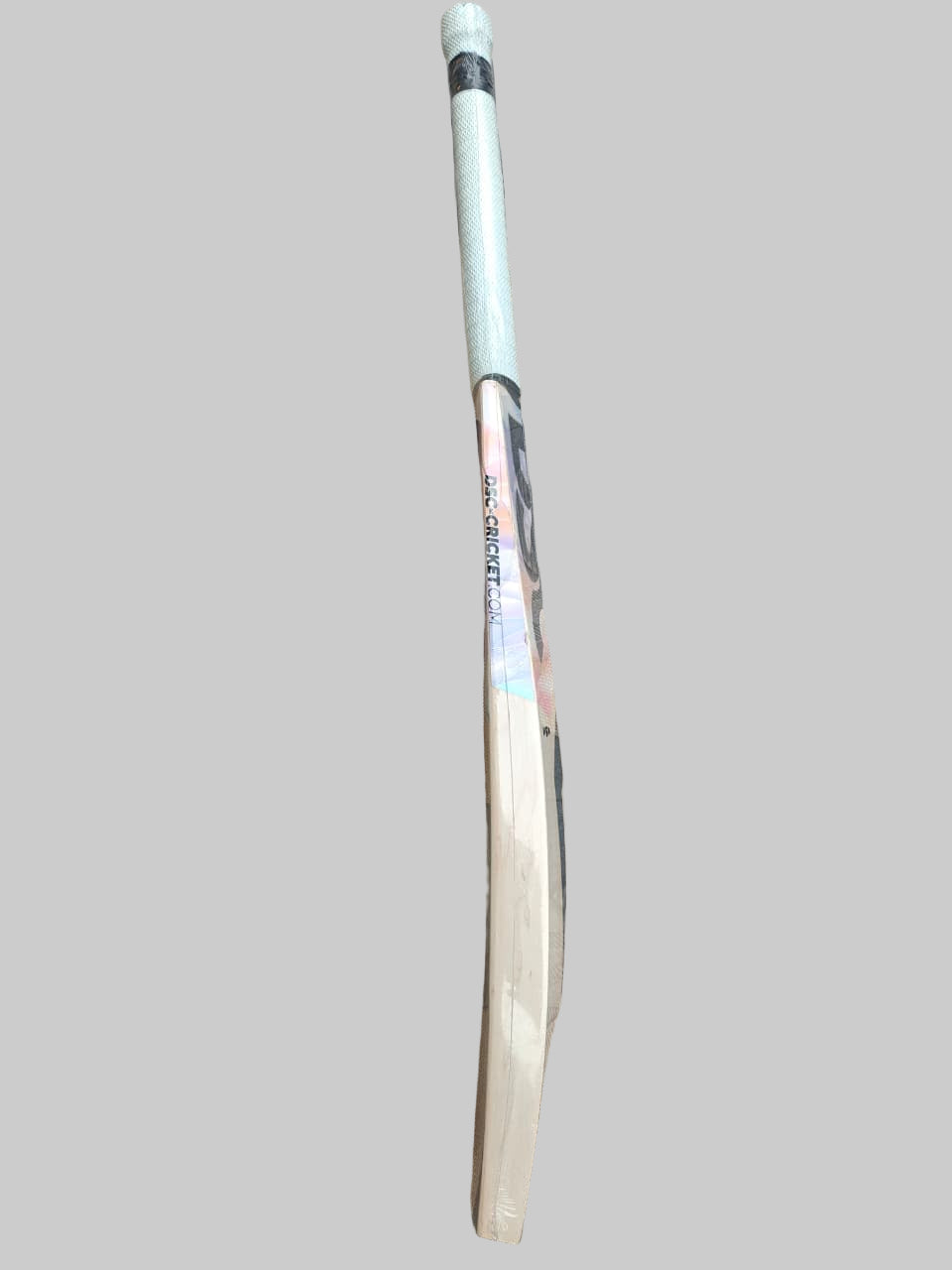 White cricket bat on a hexagonal tiled floor