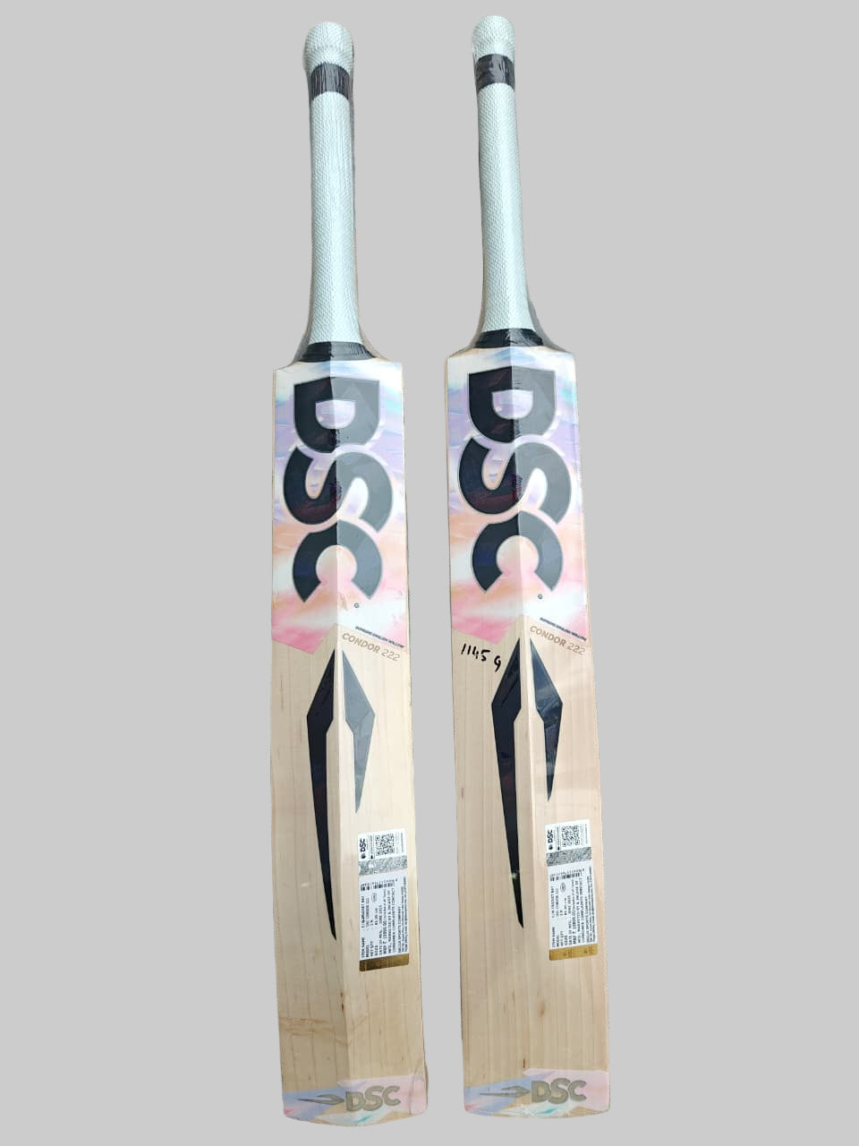 Two cricket bats with DSC branding on a tiled floor.