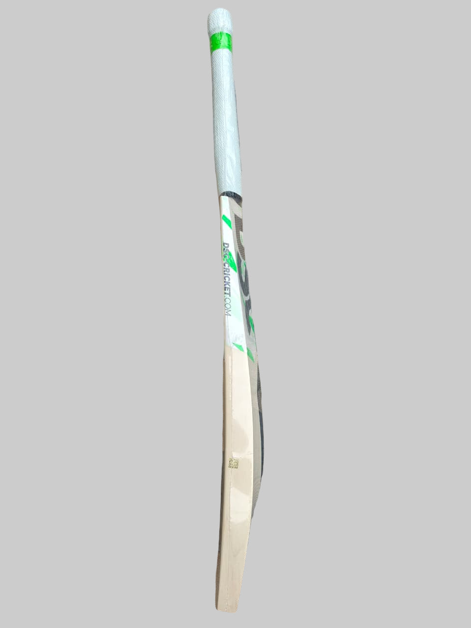 White cricket bat with green accents on a hexagonal tiled floor